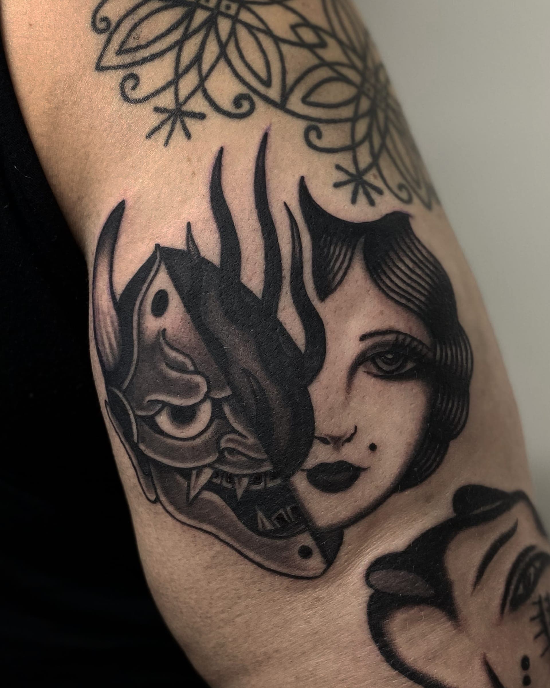 Half hannya mask and half lady face tattooed on the outer