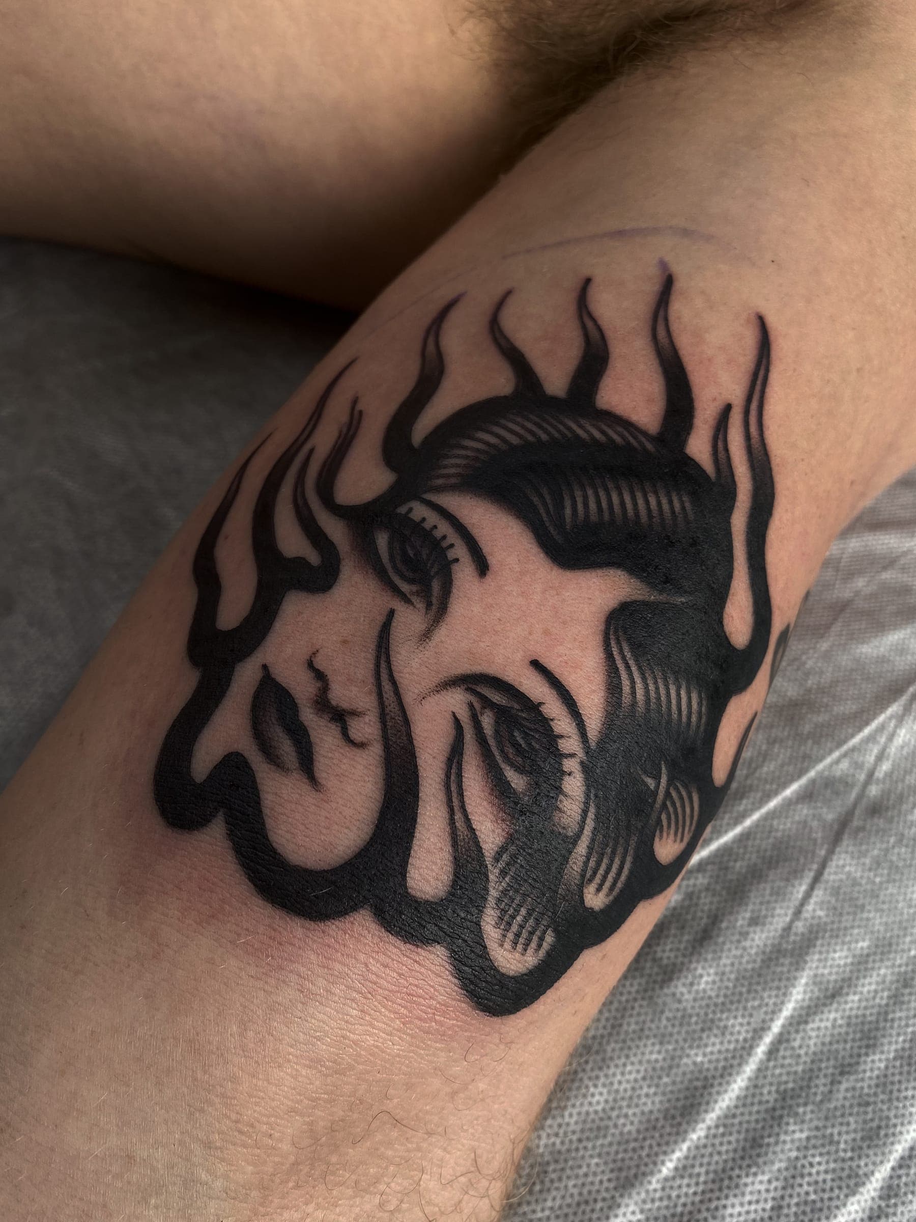 Bold blackwork lady head ringed by tongues of flame